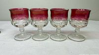 Four ruby flash King’s Crown goblets side by side