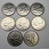 Nine Canadian 25-cent coins showing caribou reverse design
