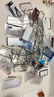 pile of packaged phone cases and metal stands