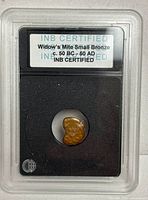 Front of INB slab showing widow's mite identification label and encapsulated coin