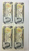 All four Canadian $1 banknotes grouped