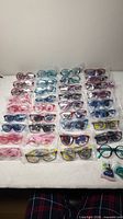 Front view showing rows of packaged kids eyeglass frames in multiple colors