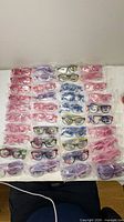 overview of multiple individually bagged eyeglasses arranged on table