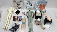 Overview of bodies, heads, clothing, accessories laid out