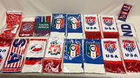 All scarves laid out in two rows, in plastic sleeves