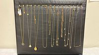 All 16 necklaces hanging to show variety of styles and lengths