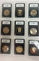 Group shot of nine INB slabbed Kennedy half dollars