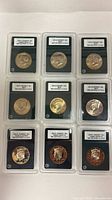 Nine INB-slabbed Kennedy half dollars arranged in three rows