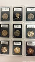 Front view of all nine slabbed Kennedy half dollars