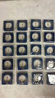 20 sealed OUFER retail boxes arranged in grid