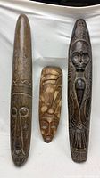 Front view of all three carved wooden masks