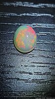 Top view of oval Ethiopian opal showing play of color