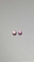 Front view of both oval pink spinels