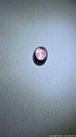 Top view of oval purple-pink spinel cabochon