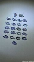Group of oval tanzanite gemstones in ambient light