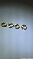 Four round golden citrine gemstones top view