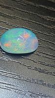 Top view of oval cabochon opal showing play-of-color