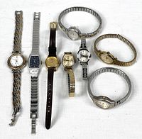 Front view of seven watches showing faces and bands