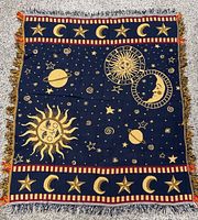 Full view of woven celestial motif throw blanket showing design and size