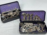 Two Greist tins open showing attachments