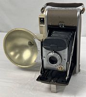 Camera with flash attached, bellows extended