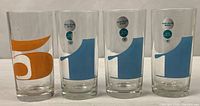 Front view of all four tumblers showing numeric graphics and label positions