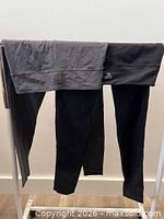 Front view of both pairs hanging, showing colours and waistband styles
