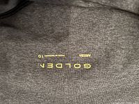 Close-up inside waistband showing Aritzia Golden branding and size 10 marking