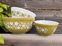 Three nested Spring Blossom Green Pyrex bowls showing pattern and color