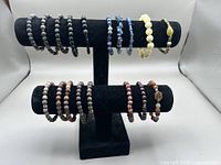 Bracelets displayed on black two-tier stand