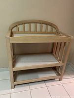 Front view of changing table showing overall structure and shelves