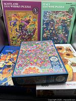 All five puzzle boxes stacked showing fronts