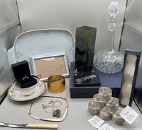 Overall lot showing platter, decanter, vase, teacup set, knife, jewellery, napkin rings, candles, paperweight, frame, amber glass jar