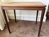 Front view of teak side table showing rectangular top and legs