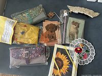Full lot overview showing wallets, bookmark, purse hook, gloves, doily, greeting cards