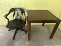 Square table and banker’s chair side by side