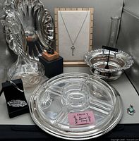 Overall view showing all nine items including tray, bowl, platter, figurine, jewellery pieces