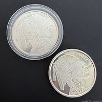 Two silver rounds, obverses visible