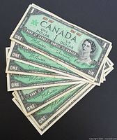 Obverse of seven stacked Centennial $1 notes showing Queen Elizabeth II portrait and 1867-1967 marking