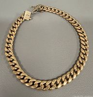 Full view of gold Cuban link bracelet closed