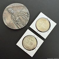 Group view of the medal and two coins