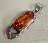 Front view showing amber cabochon and silver frame