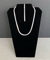 Necklace and bracelet displayed on stand