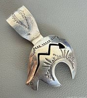 Front view of sterling silver bear pendant brooch showing stamped design, lightning cut-out and bail