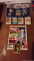 Full lot overview showing figures, magazine, cards, and sealed products