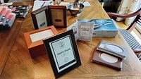 Assorted frames, albums, knife box on table