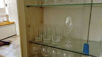 Highball tumblers and wine glass on display shelf