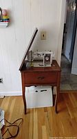 cabinet closed with lid open showing machine