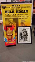 Group shot of coin bank in box, 1990 yellow poster, framed signed photo