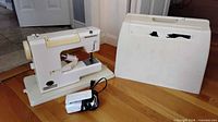 Sewing machine, case, foot pedal and cord